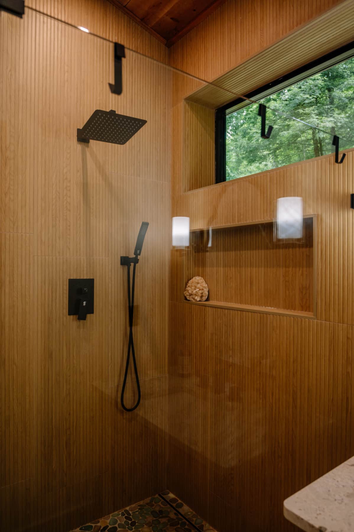 Private hot tub on the deck at night — stars overhead, soft string lights, steam rising in cool air, forest silhouette